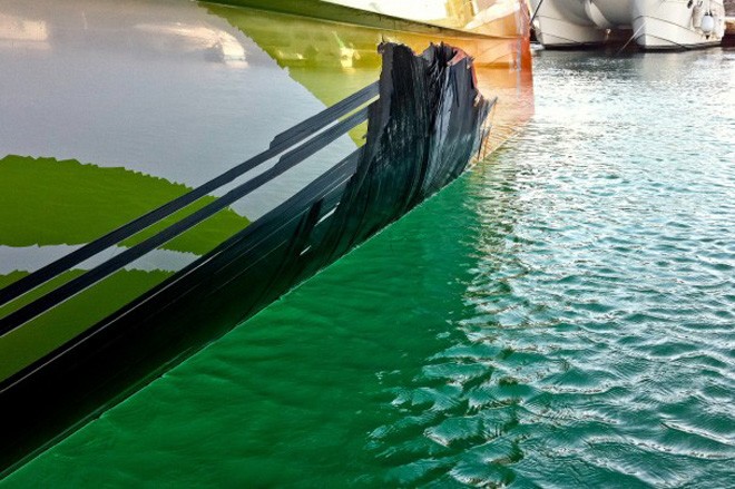 Team Sanya in the Mediterranean port of Motril assessing the state of their boat after hull damage forced them to suspend racing on Leg 1 of the Volvo Ocean Race 2011-12 © Team Sanya